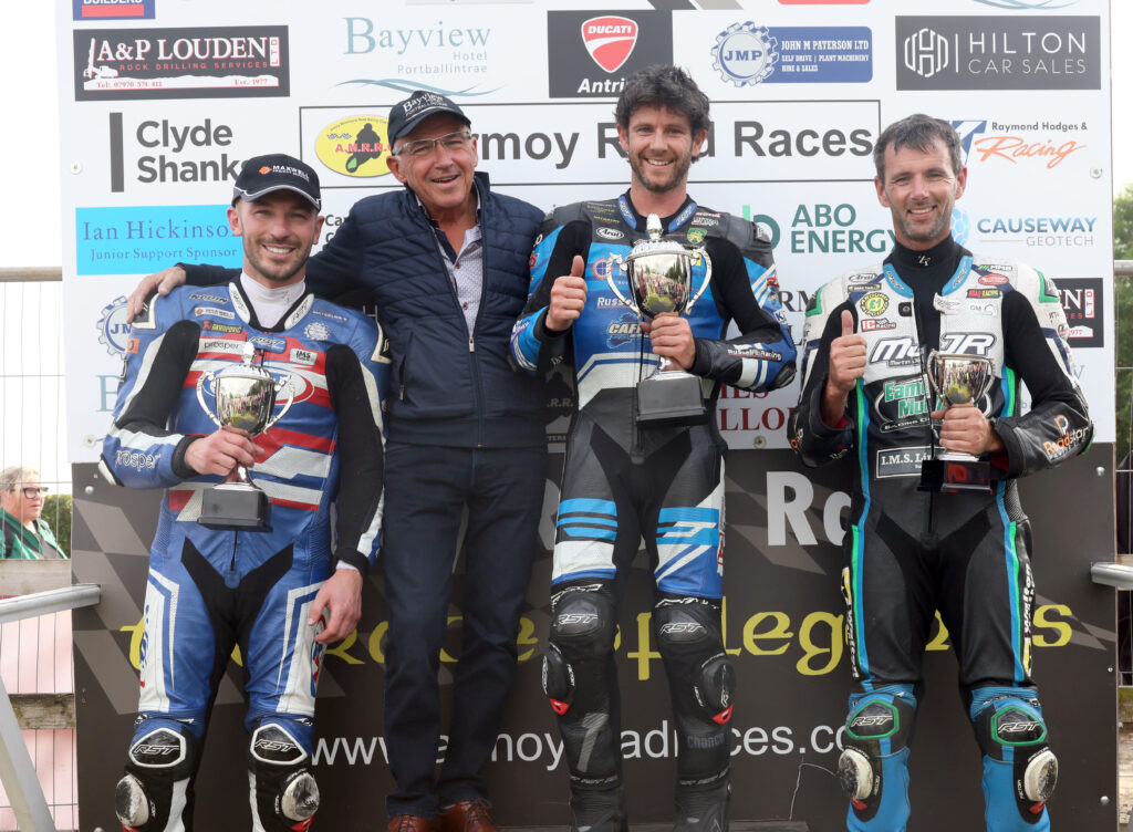 PACEMAKER, BELFAST, 25/7/2025: Race of Legends at Armoy road races winner Mike Browne (BPE/Russell Racing Honda), runner-up, Paul Jordan and third placed Michael Sweeney are congratulated by title sponsor, Trevor Kane of the Bayview Hotel.
Picture by Stephen Davison