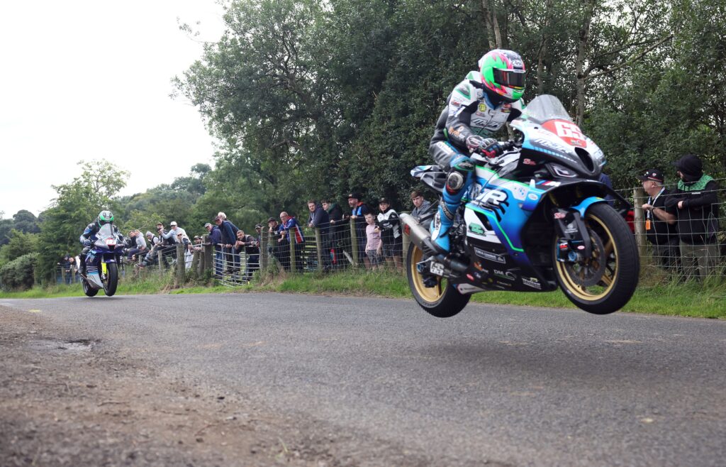 PACEMAKER, BELFAST, 25/7/2025: Michael Sweeney (MJR BMW) leaps Lagge Jumps ahead eventual Race of Legends at Armoy road race winner, Mike Browne (BPE Russell Racing Honda).
Picture by Stephen Davison